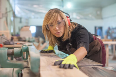 Female carpenter Using Electric Sander / Female carpenter Using